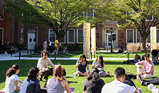 Students sitting outside. Links to Gifts of Cash, Checks, and Credit Cards